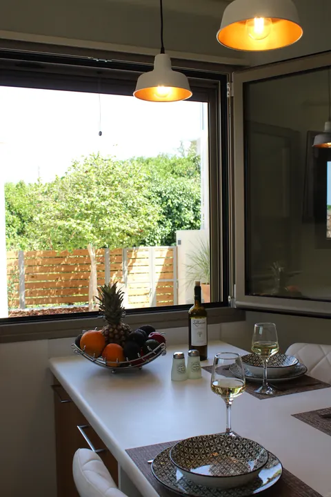 Pendant lamps over the table by the open window