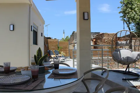 The breakfast table with the hanging chair and the village beyond